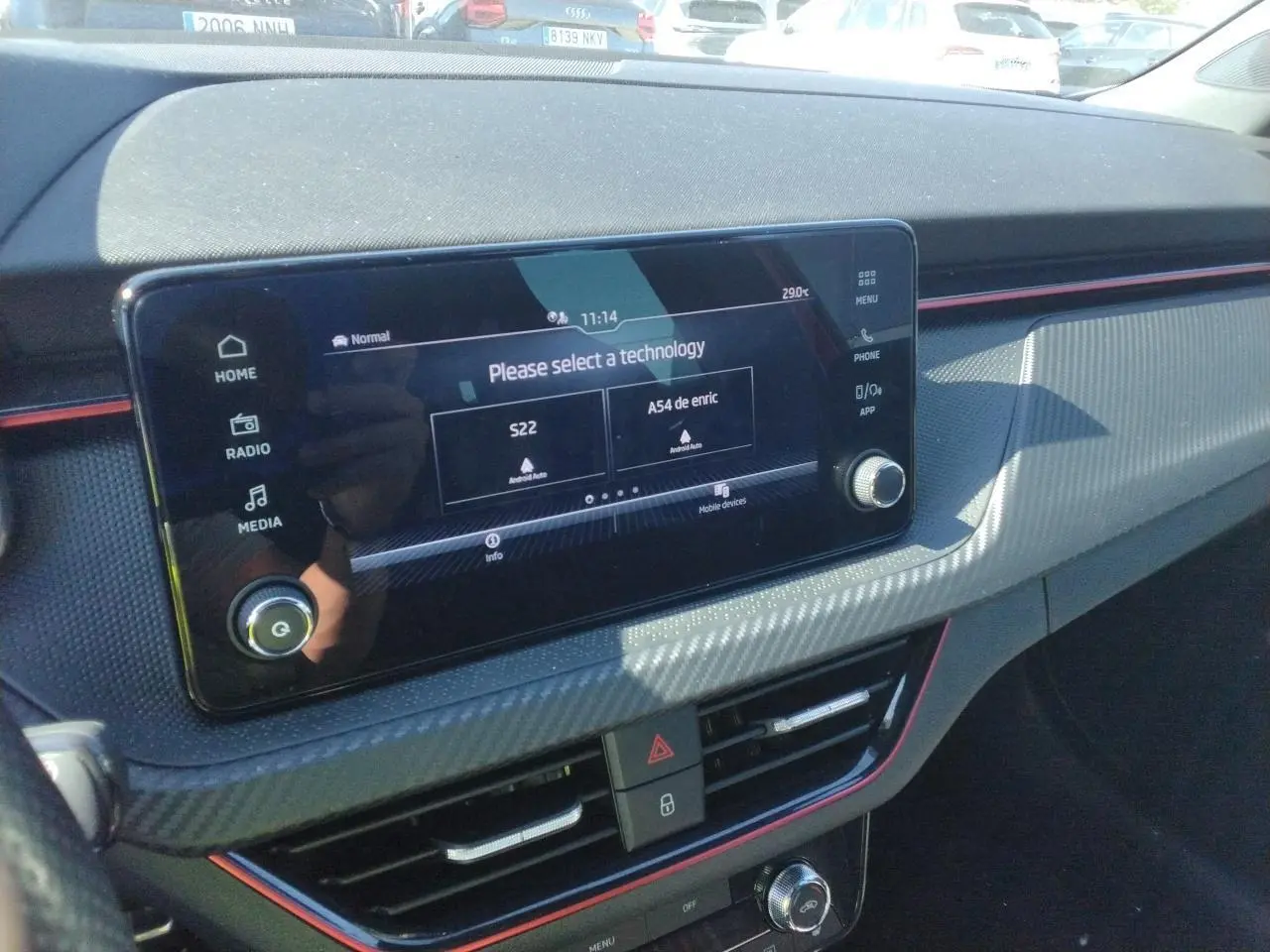 Vue intérieure du tableau de bord du Skoda Kamiq Monte-Carlo 2025 avec écran tactile et inserts effet carbone rouge.