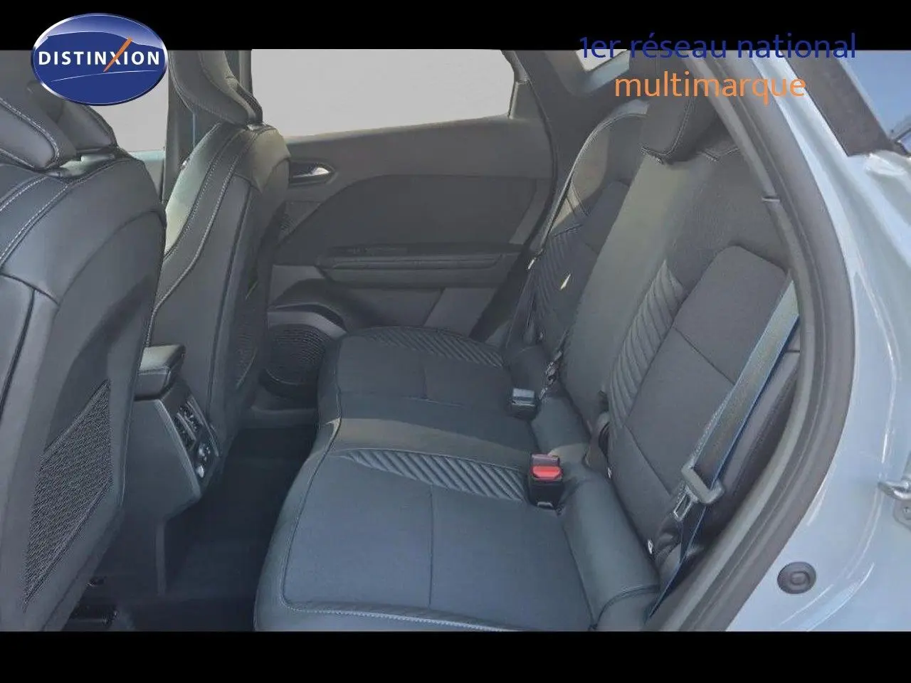 Vue intérieure arrière côté droit du Renault Captur E-Tech hybride 2025 avec sièges tissu noir et détails gris.