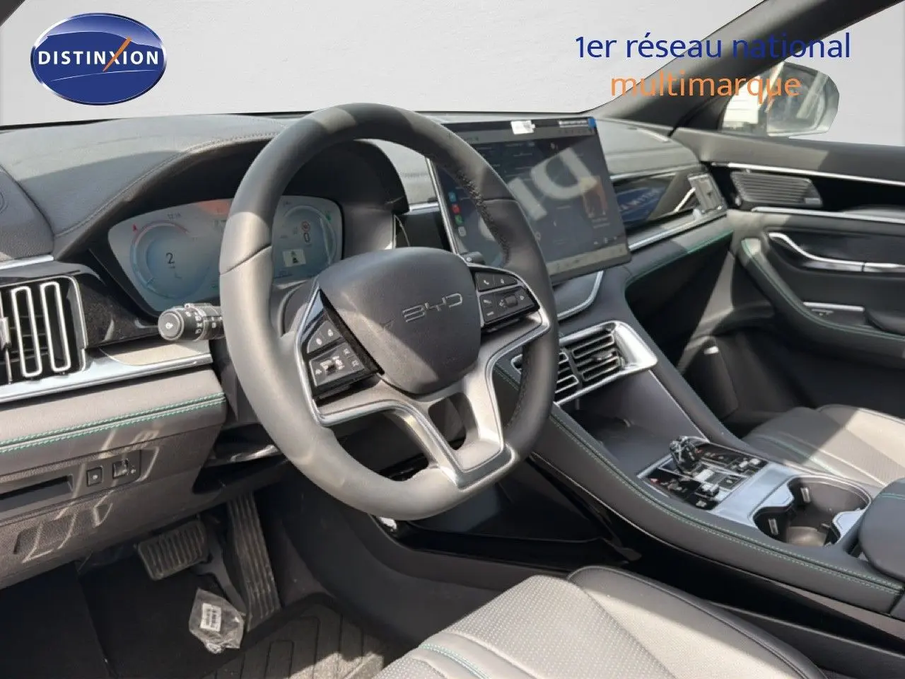 Vue intérieure côté conducteur du BYD SEAL U DM-i BOOST, volant cuir, tableau de bord numérique et écran tactile central.