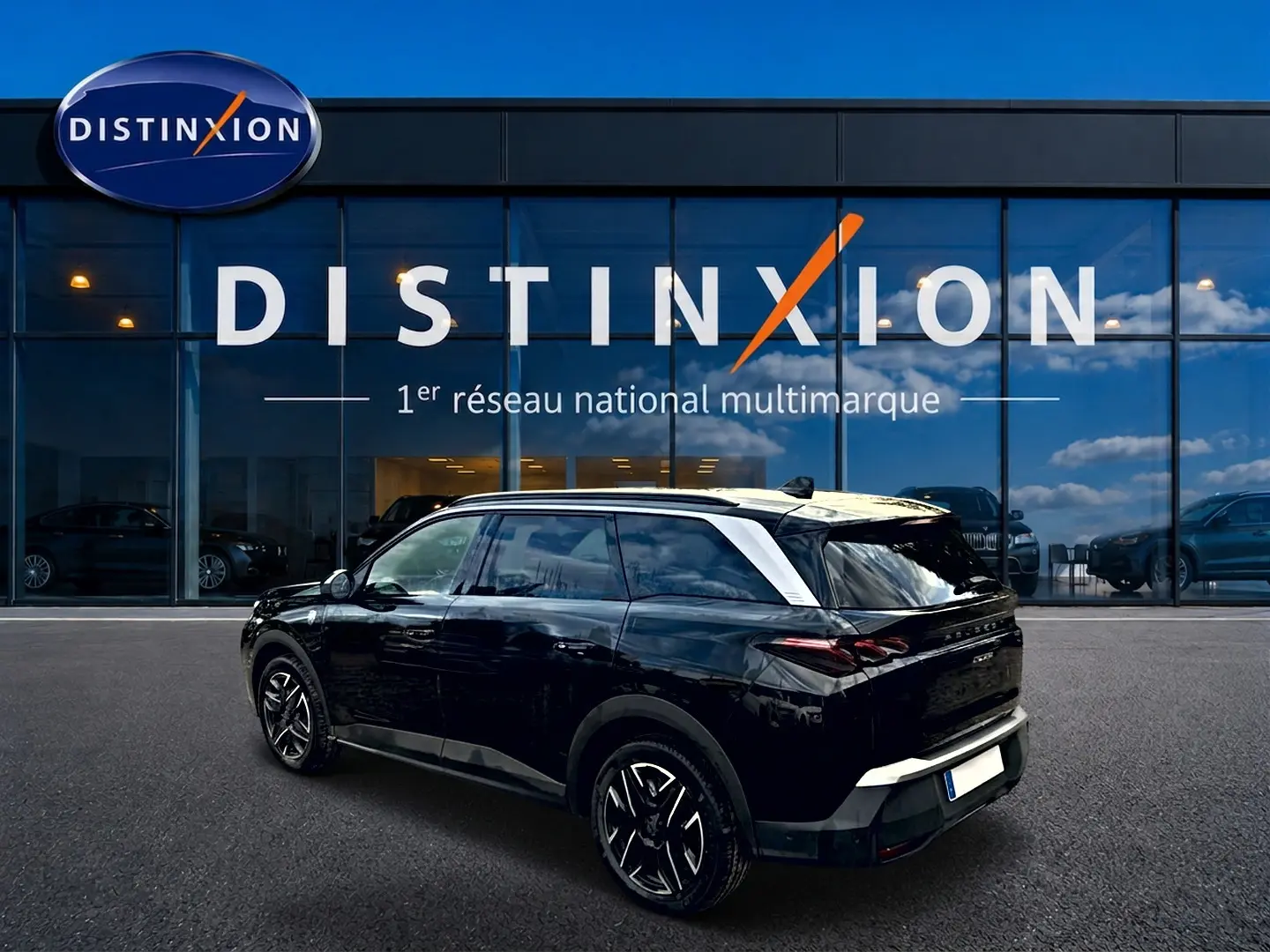 Peugeot 5008 Hybrid 145 GT noir en 3/4 arrière droit, avec jantes alu et toit contrasté blanc.
