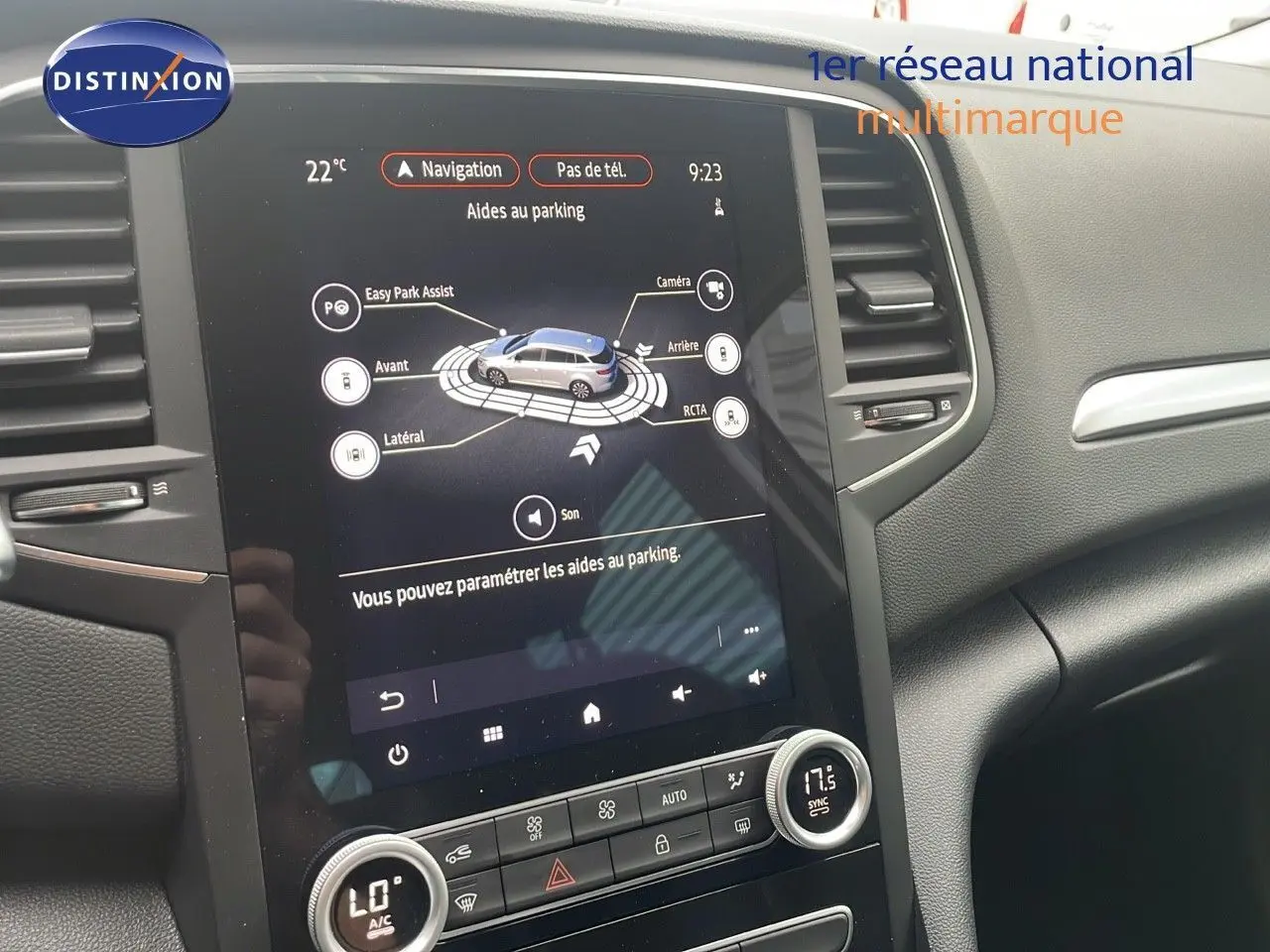 Écran tactile central affichant l'aide au parking de la Renault Mégane Break gris Highland Metal, intérieur noir moderne.