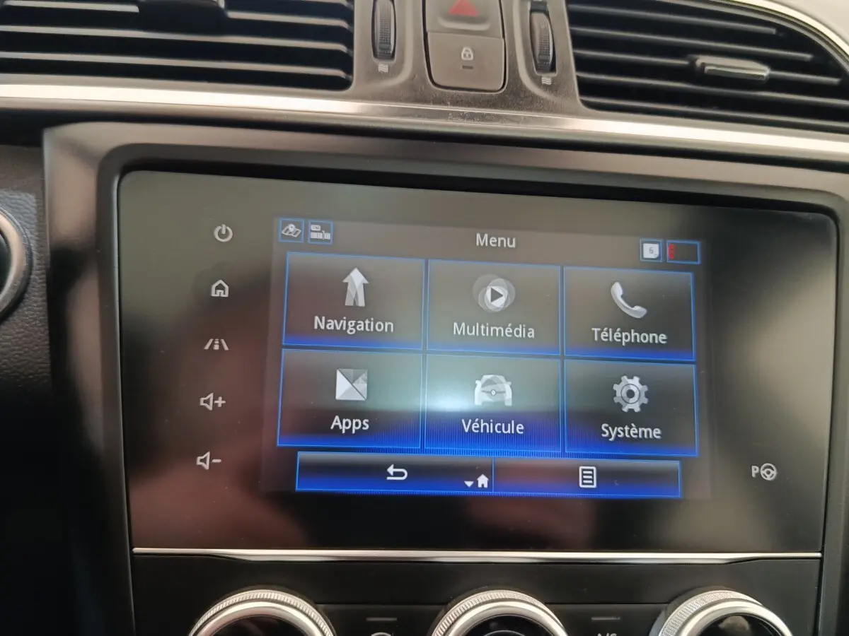 Écran tactile central du tableau de bord du Renault Kadjar blanc, affichant le menu principal multimédia et navigation.