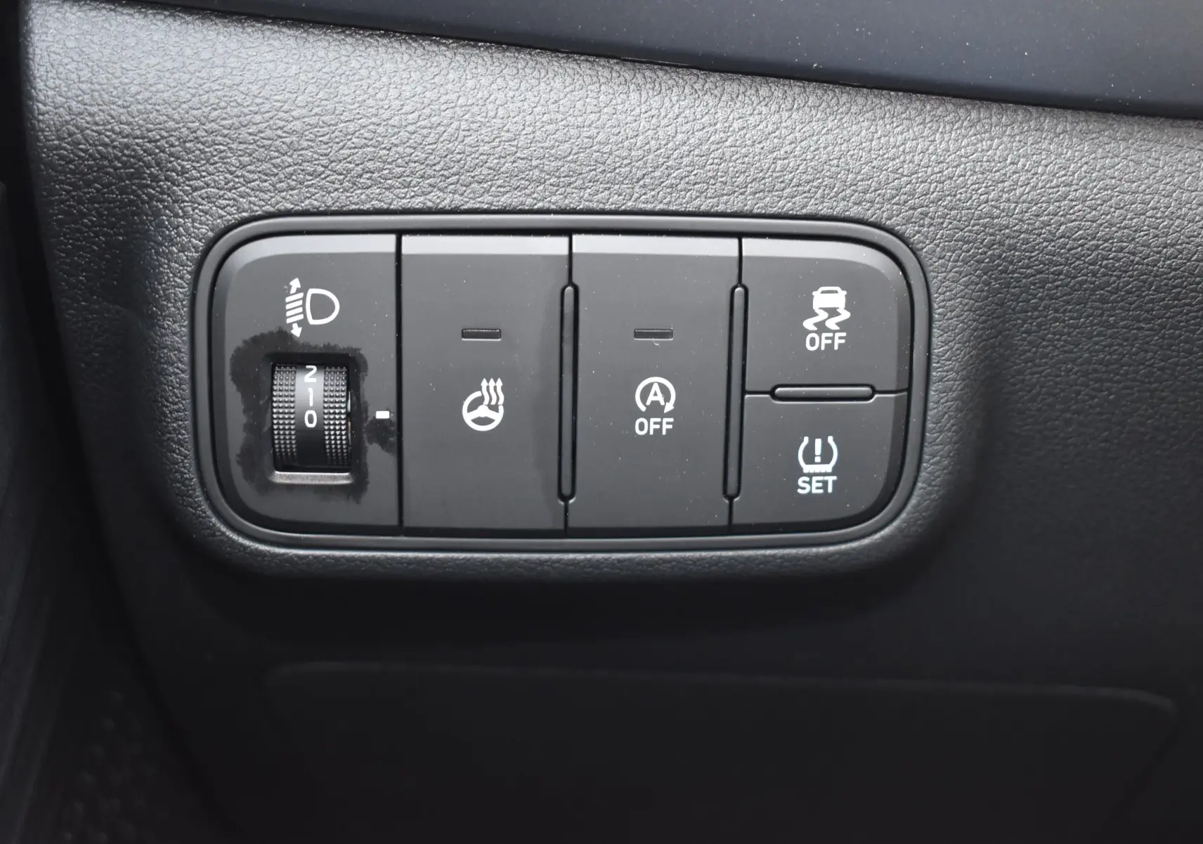 Gros plan sur les commandes de réglage d’éclairage, chauffage volant et aides à la conduite dans un Hyundai i20 2025.
