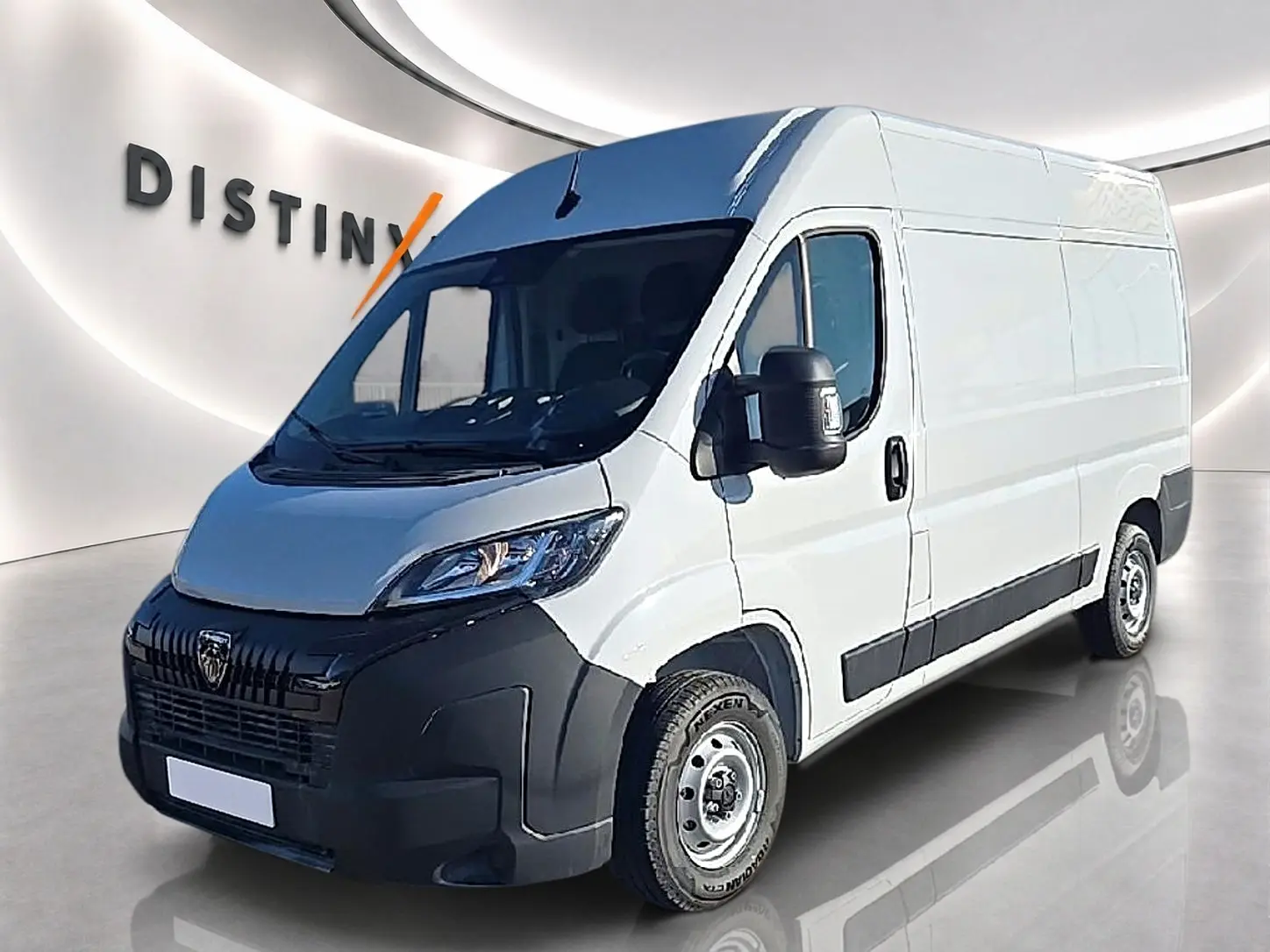 Vue 3/4 avant droit du Peugeot Boxer Fourgon blanc avec porte latérale coulissante et pare-chocs noir.