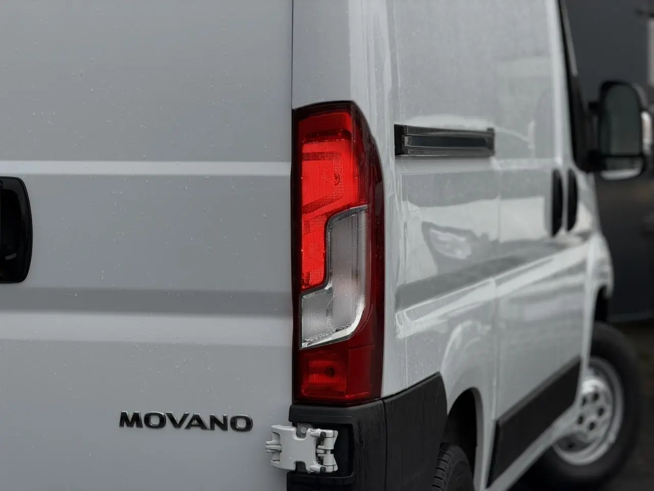 Gros plan sur l’arrière droit blanc de l’Opel Movano Fourgon avec feu arrière et logo visible.