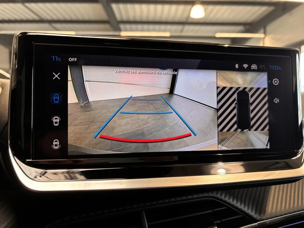 Écran tactile intérieur montrant la caméra de recul et vue 360° du Peugeot 2008 noir hybride, interface moderne.