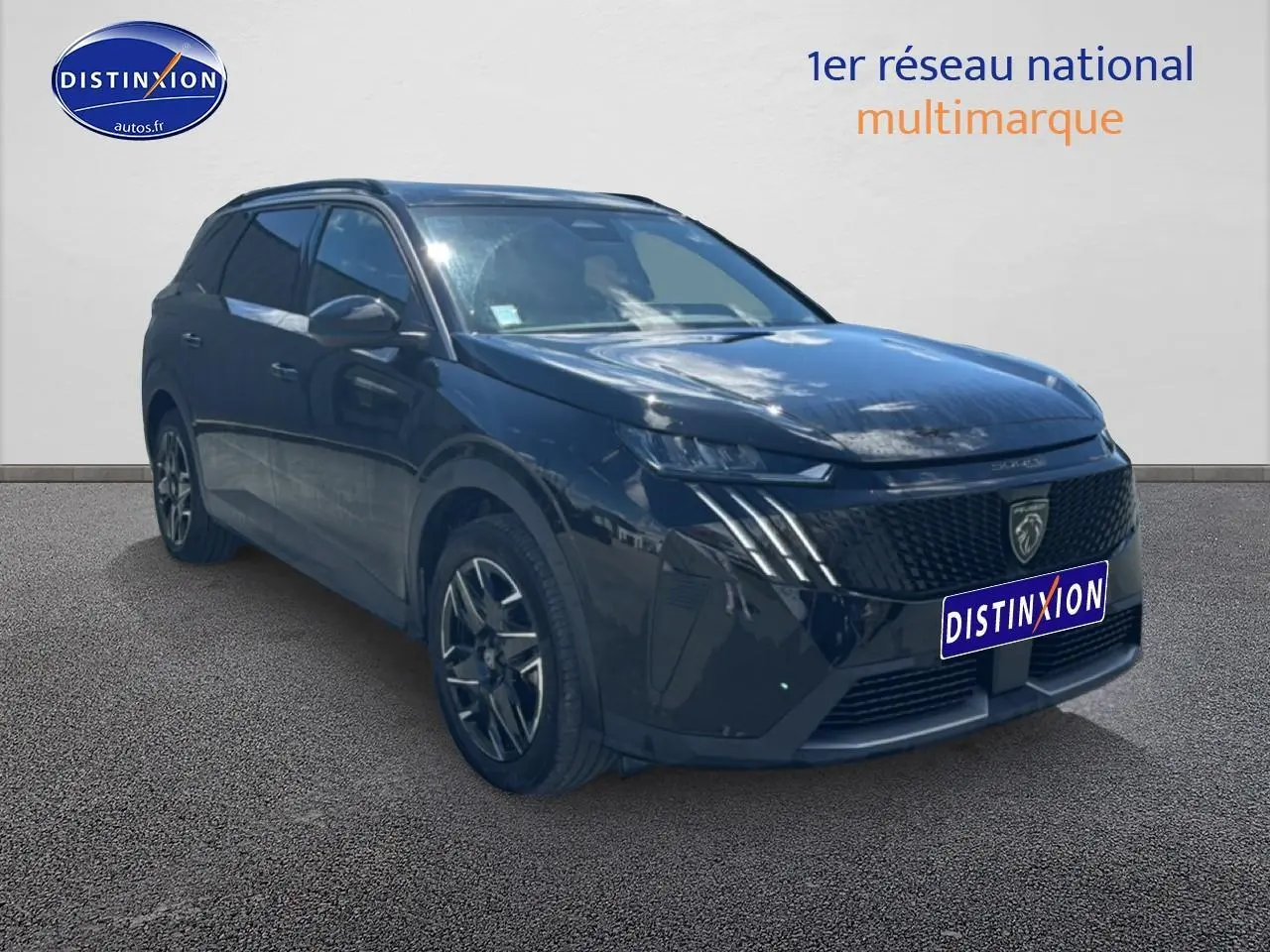 Peugeot 5008 noir en 3/4 avant droit, mettant en valeur sa calandre distinctive et ses phares LED fins.
