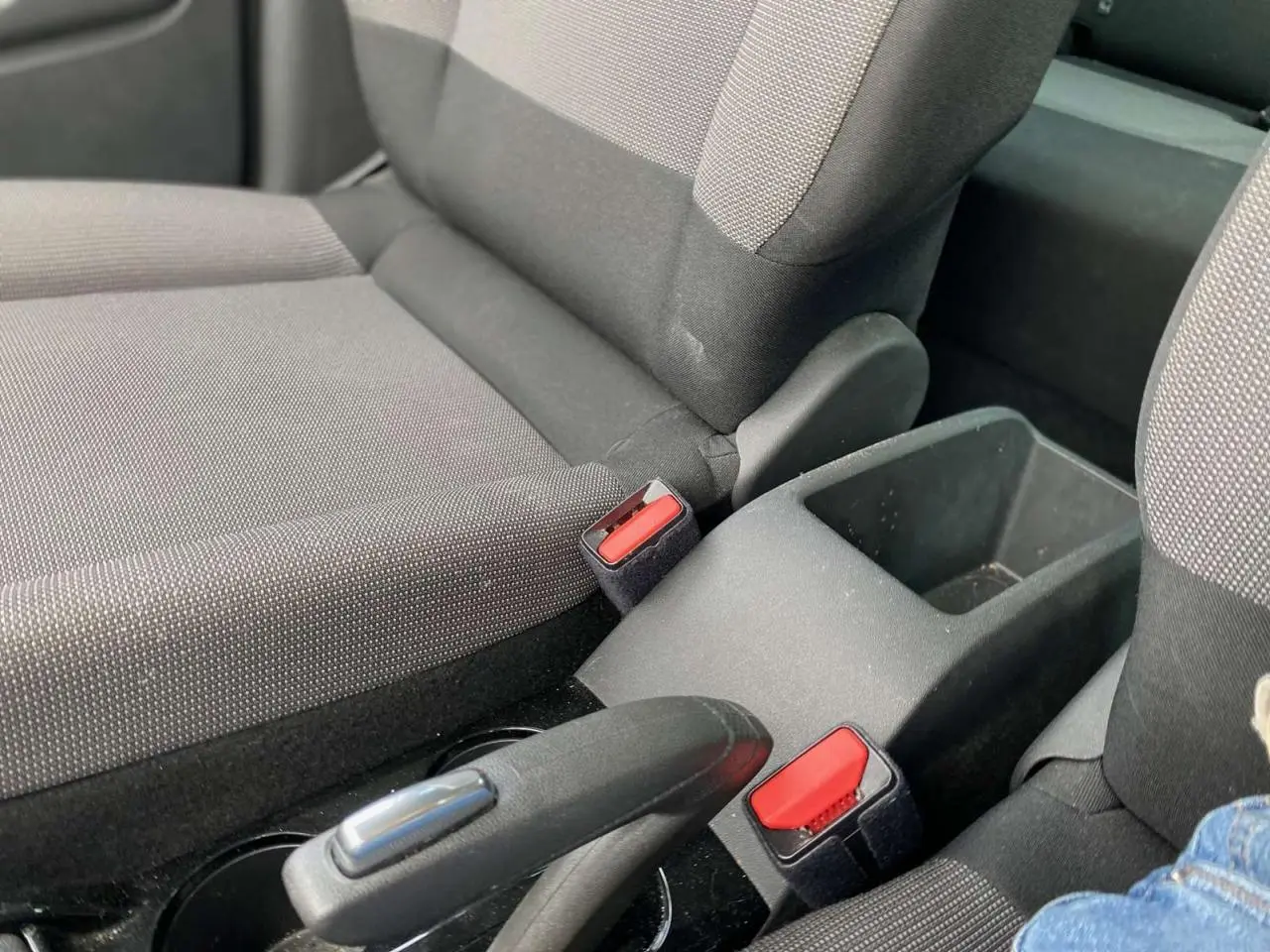 Gros plan sur les sièges avant et la console centrale du Citroën C3 Aircross 2023, avec ceintures rouges visibles.