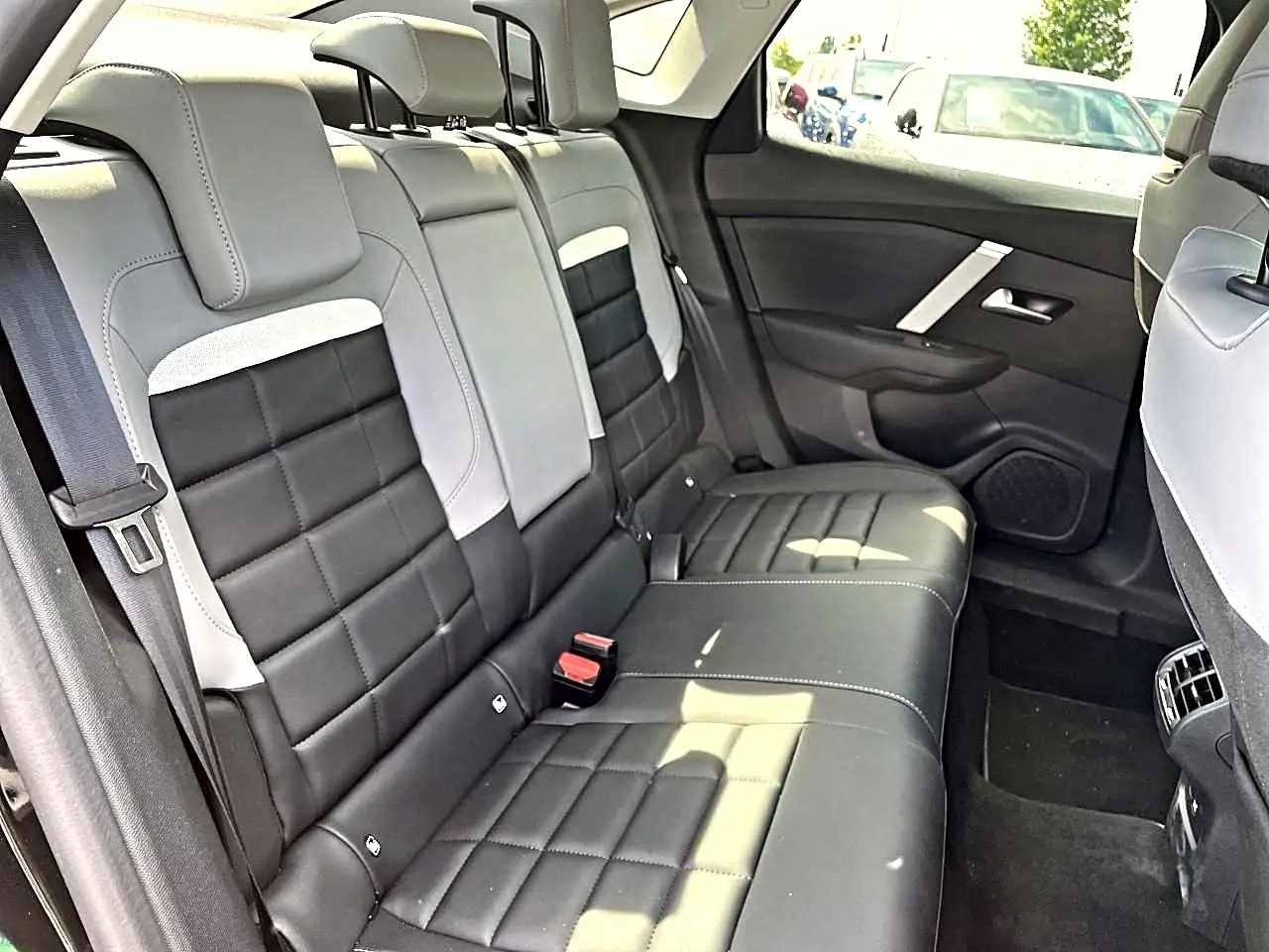 Vue intérieure montrant la banquette arrière bicolore noire et grise du Citroën C4 X 2025 côté droit.
