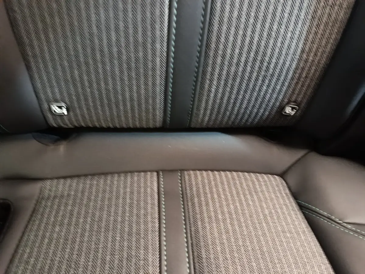 Gros plan sur la banquette arrière en tissu et cuir noir du Peugeot 3008 hybride rechargeable 2023.