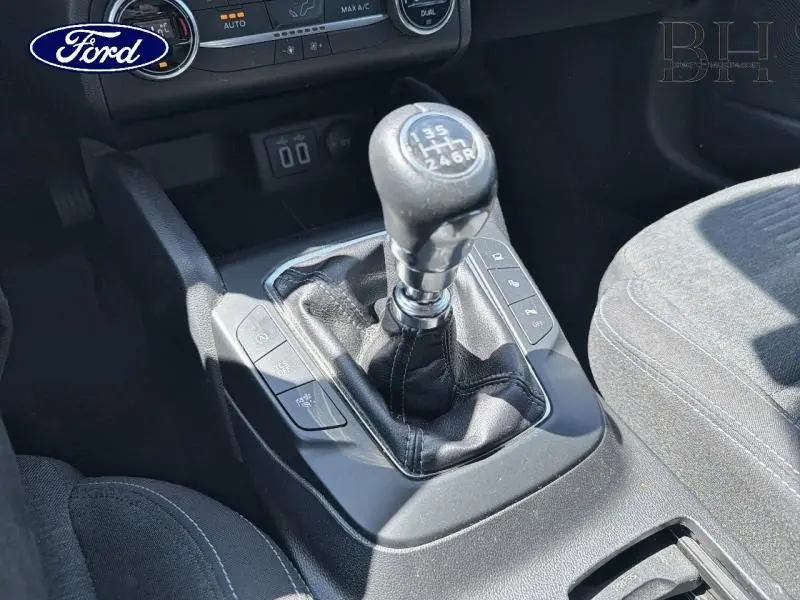 Gros plan sur le levier de vitesses manuel de la Ford Focus 1.0 Flexifuel 125ch, intérieur tissu noir.