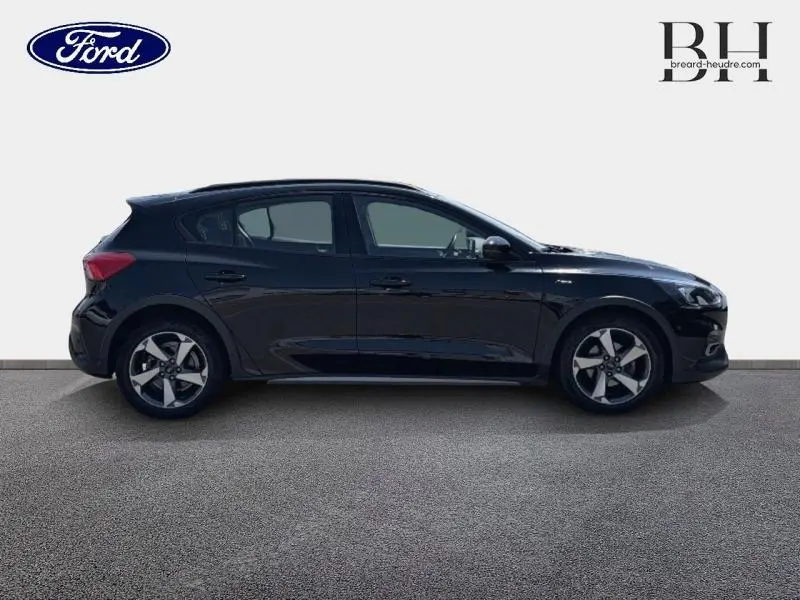 Ford Focus 1.0 Flexifuel 125ch Business noir Agate métallisé vue de profil côté gauche avec jantes alliage.