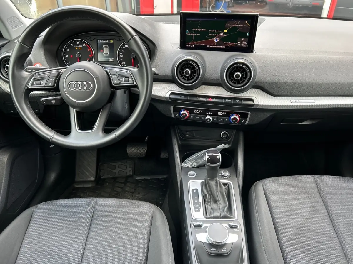 Vue intérieure du tableau de bord et console centrale de l'Audi Q2 noir 35 TFSI 150 S Tronic S Line 2023.