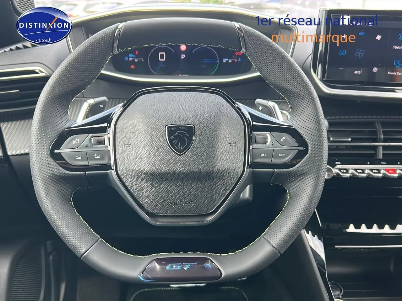 Vue centrée sur le volant cuir noir du Peugeot 2008 1.2 hybrid 145 GT avec tableau de bord numérique et écran tactile.