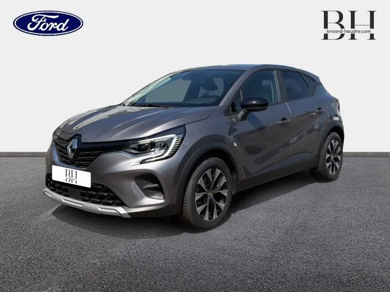 Renault Captur 1.6 E-Tech hybride gris Cassiopée métallisé en 3/4 avant droit avec jantes alliage et feux LED.