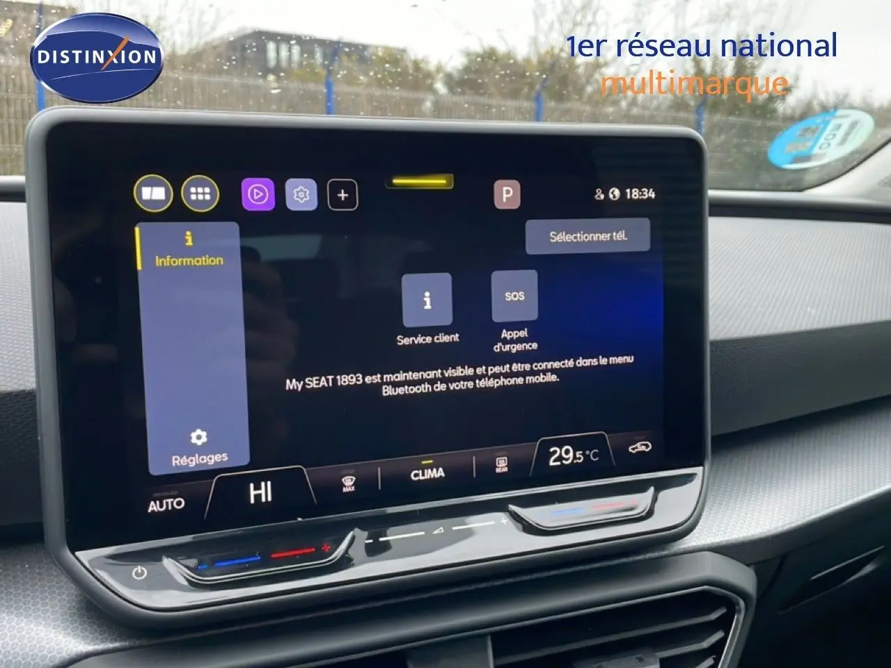 Vue intérieure centrée sur l'écran tactile du tableau de bord du SEAT Leon gris Fiord, affichant les réglages climatiques.