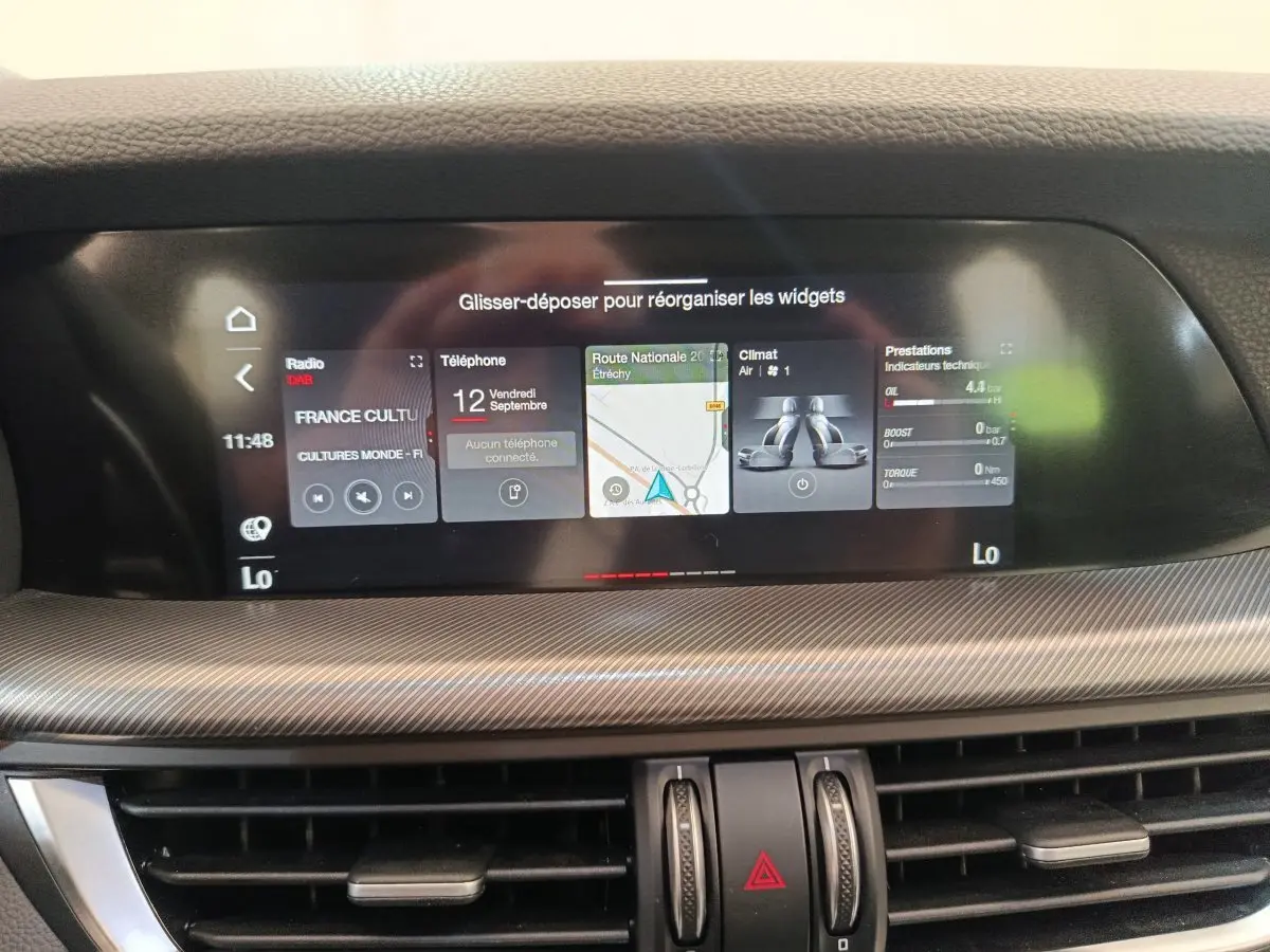 Écran tactile central 22,4 cm de l'Alfa Romeo Stelvio gris foncé, affichant navigation et fonctions multimédias.