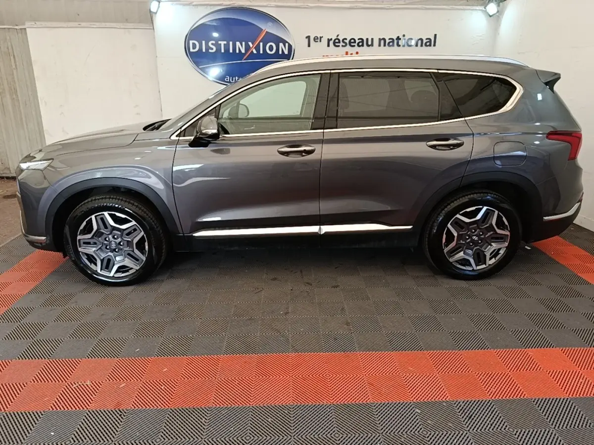 Vue de profil côté gauche du Hyundai Santa Fe gris foncé 2023 avec jantes alliage et vitres teintées.