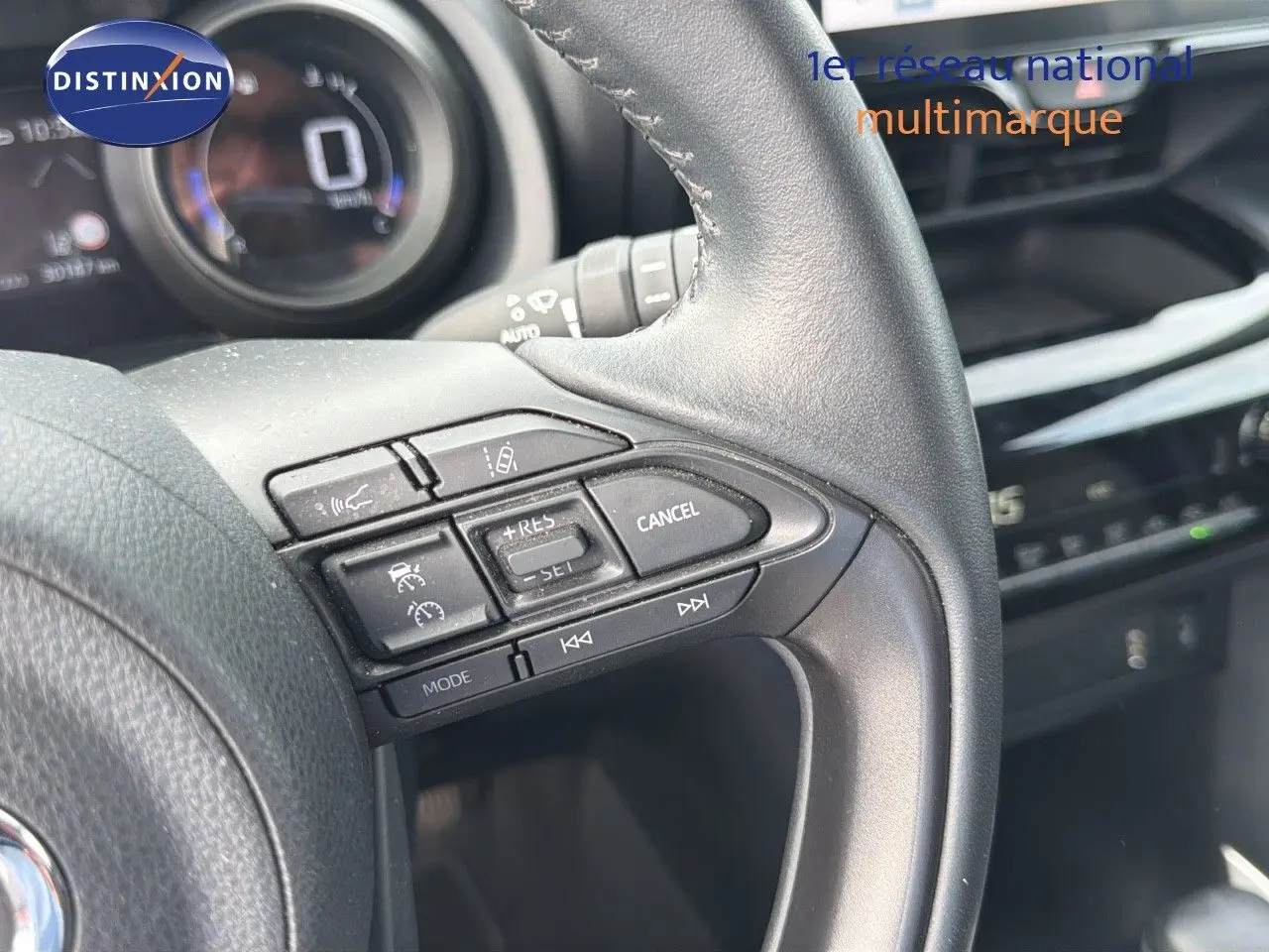 Gros plan sur les commandes au volant en cuir noir de la Toyota Yaris Cross 116h Design AWD-i 2023.