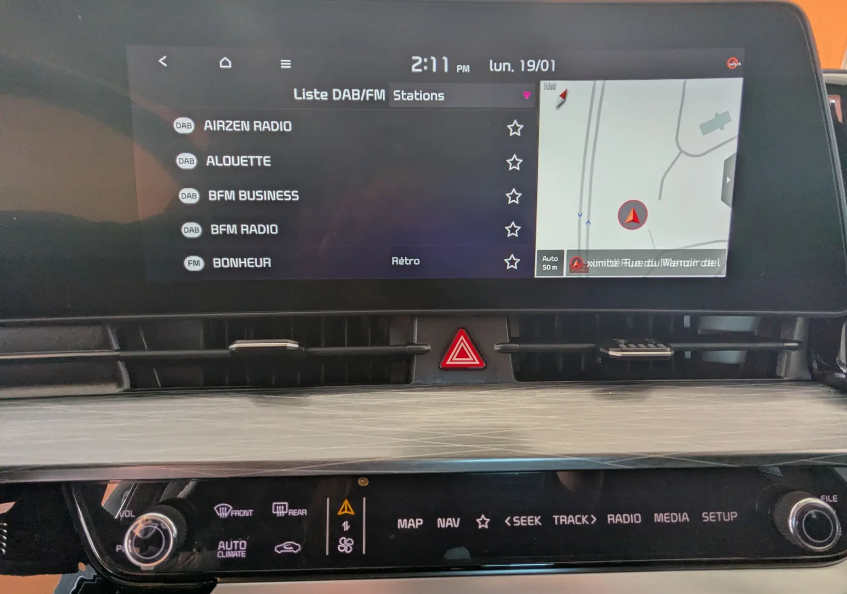 Écran tactile 12,3’’ du système de navigation Kia Sportage 2025, affichant liste radio DAB et carte GPS.
