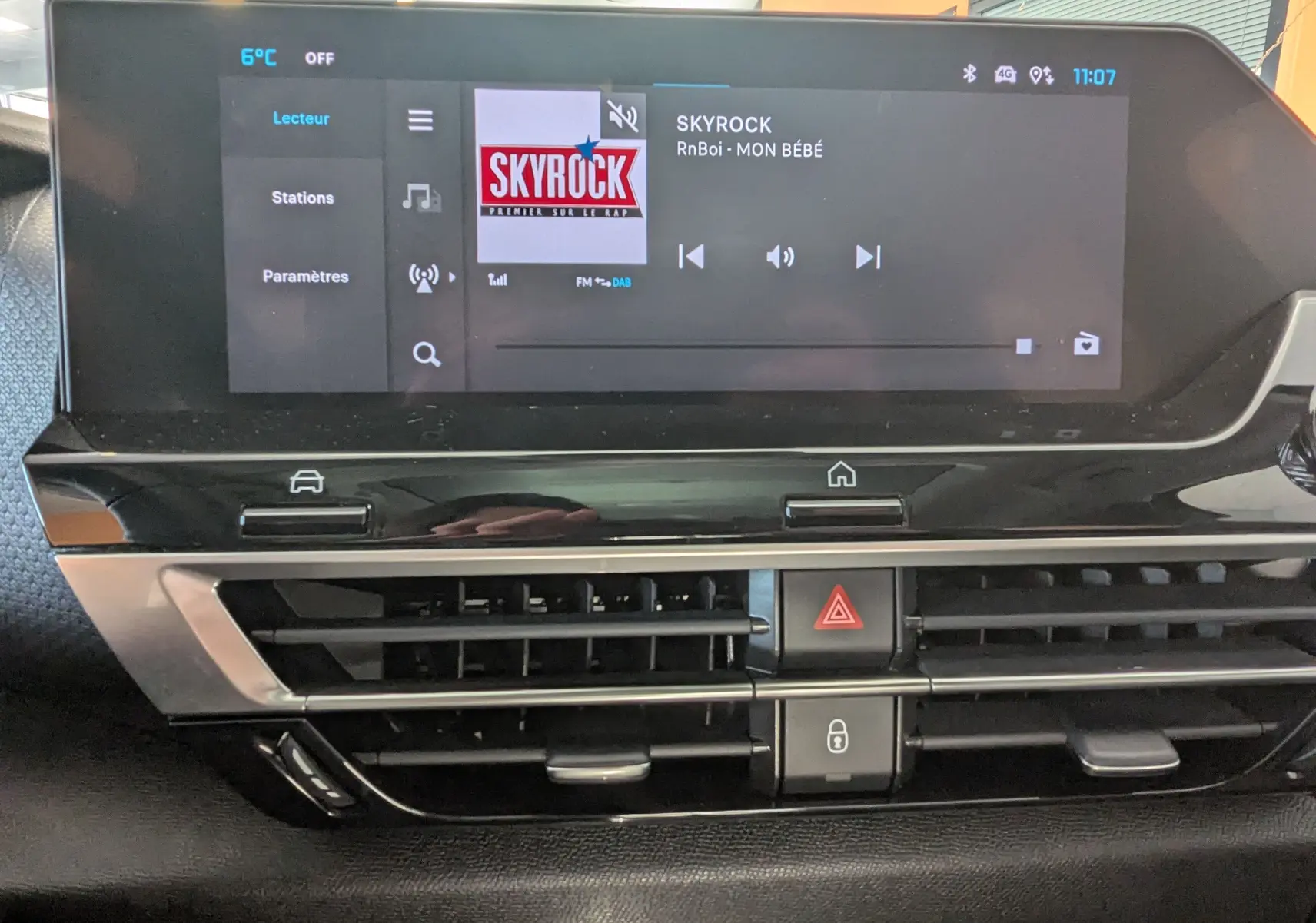 Écran tactile central du tableau de bord du Citroën C4 gris platinium, affichant la radio Skyrock et commandes climatisation.