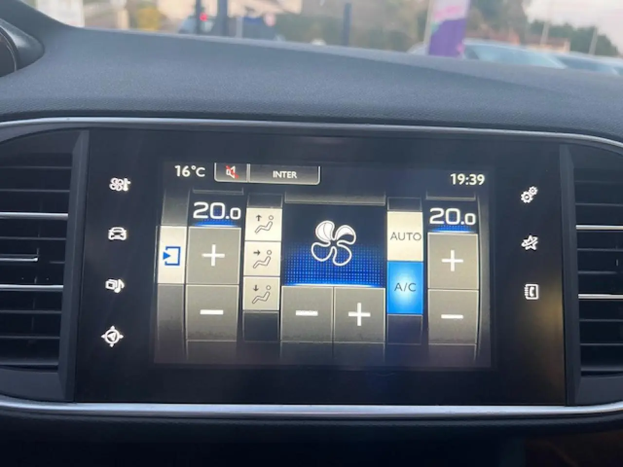 Écran tactile multifonction de la Peugeot 308 blanc, affichant les réglages de climatisation automatique bi-zone.