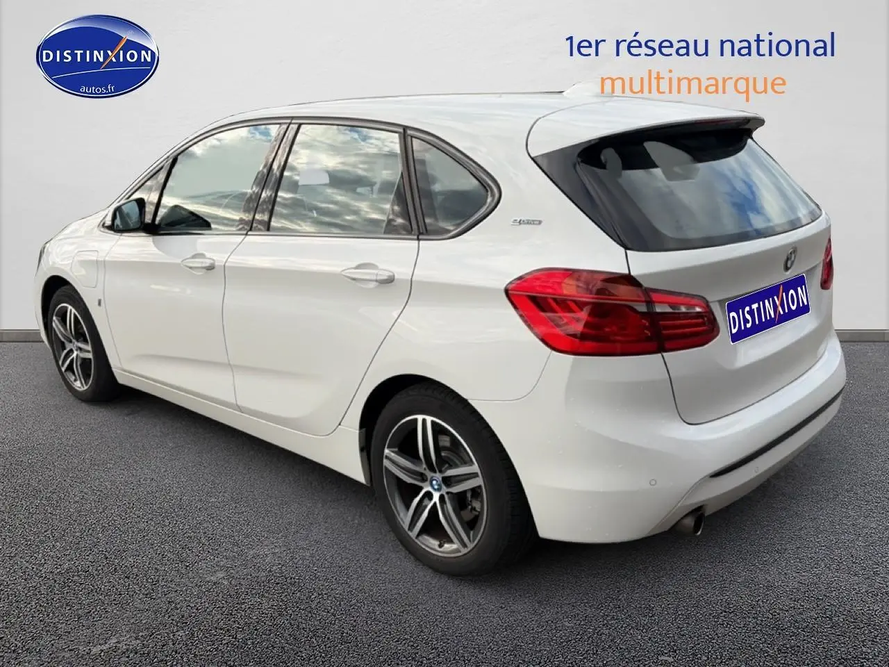 Vue 3/4 arrière droite d'une BMW Série 2 Active Tourer gris argent avec jantes alliage et becquet arrière noir.