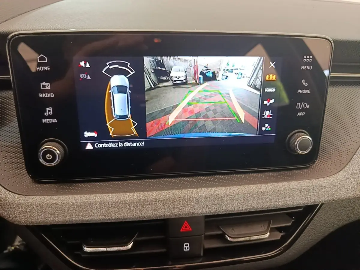 Écran tactile central montrant la caméra de recul et l’aide au stationnement du Skoda Scala 2024.