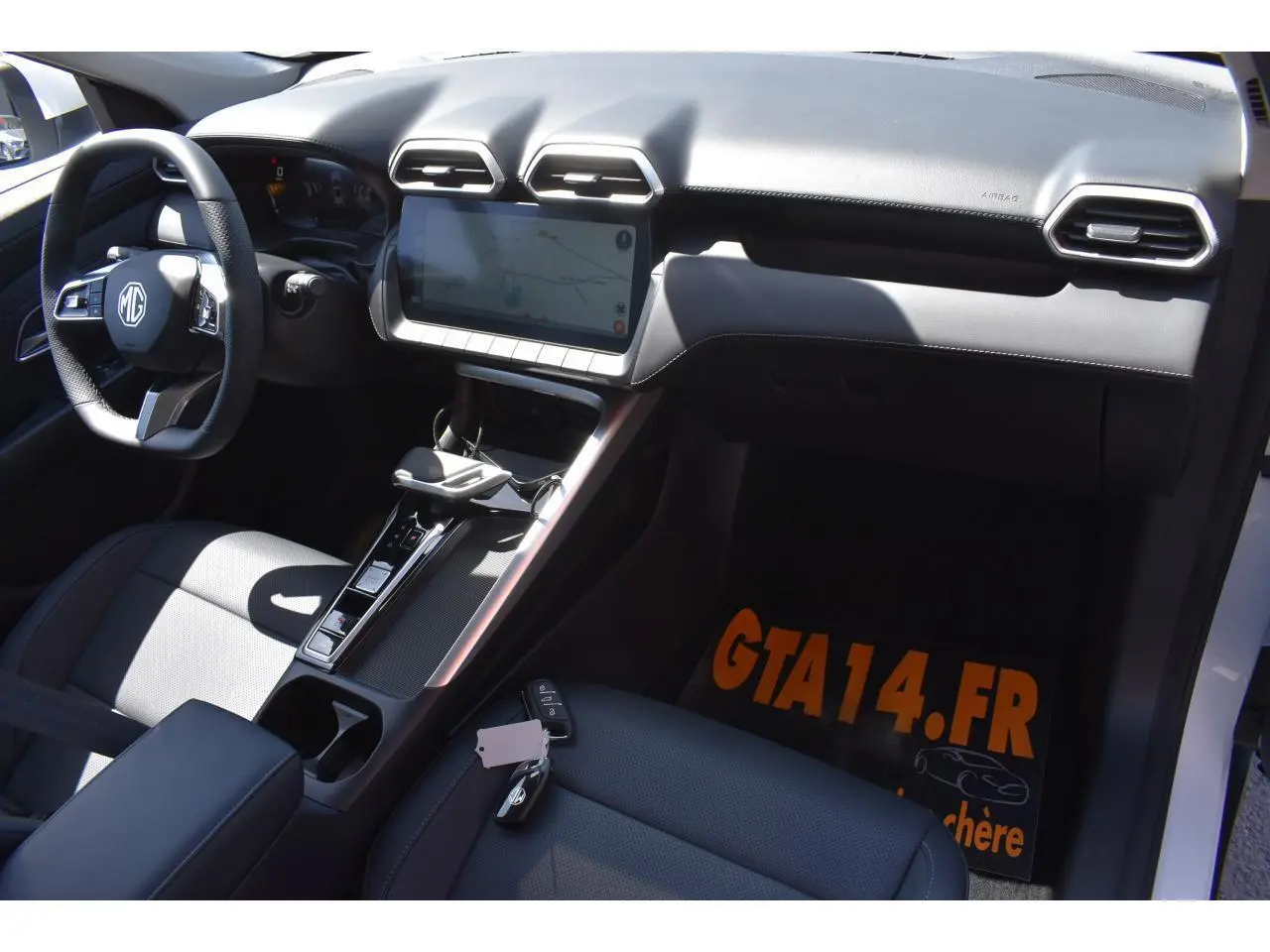 Vue intérieure côté conducteur du MG ZS blanc 2026, mettant en valeur le tableau de bord moderne et la console centrale.
