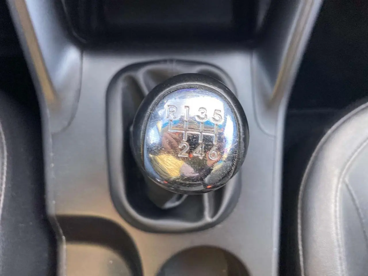 Le levier de vitesses manuel chromé du Hyundai ix35 blanc, vue rapprochée de la console centrale.