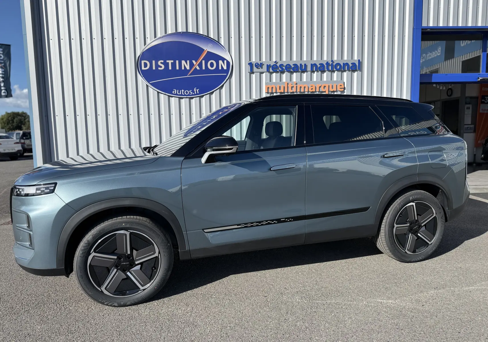 Vue de profil côté gauche du SUV JAECOO J7 PHEV gris olive, avec jantes noires et toit noir contrastant.