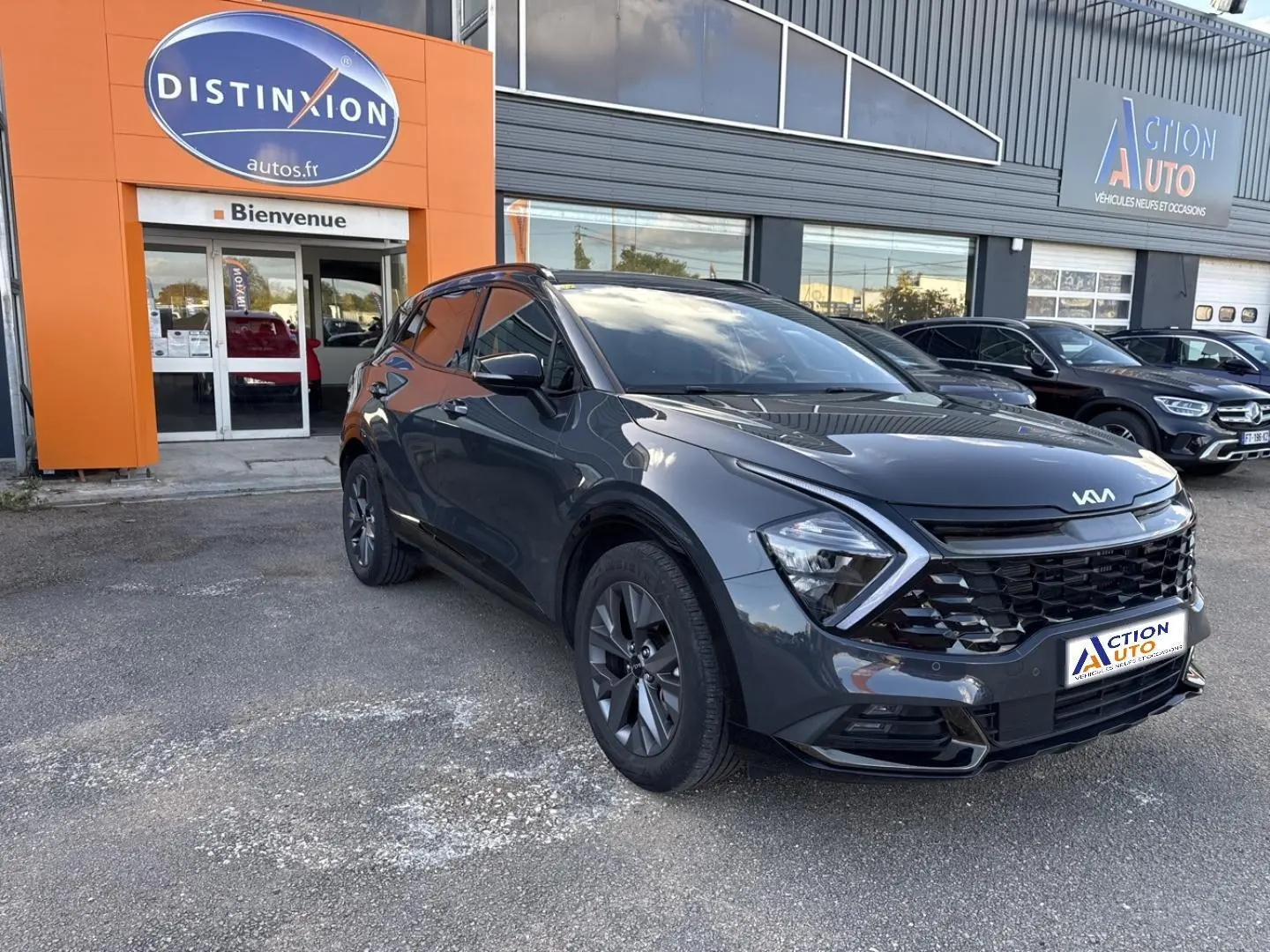 KIA Sportage gris Eclipse métallisé en 3/4 avant droit, avec calandre noire et phares LED distinctifs.