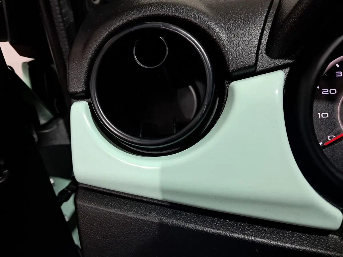 Détail de la sortie d'air circulaire côté conducteur sur tableau de bord vert clair de l'AIXAM MINAUTO E chic 2026.