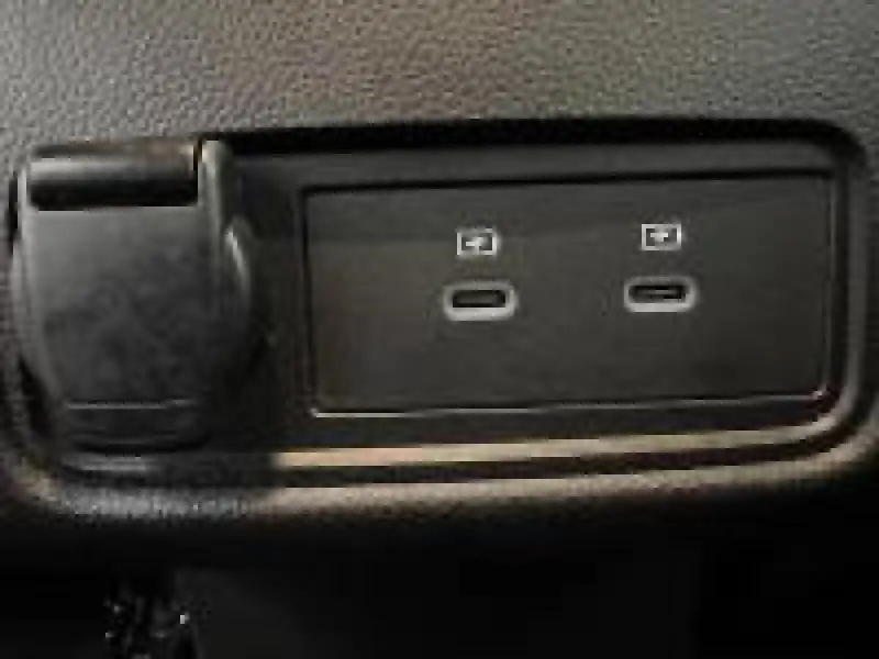 Gros plan sur deux ports USB-C noirs intégrés dans la console intérieure du Renault Captur rouge 2025.