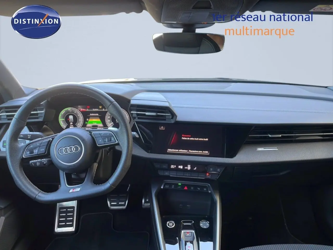 Vue intérieure avant de l'Audi A3 Sportback 40 TFSIe S-Line 2025, tableau de bord noir avec volant multifonction et écran digital.