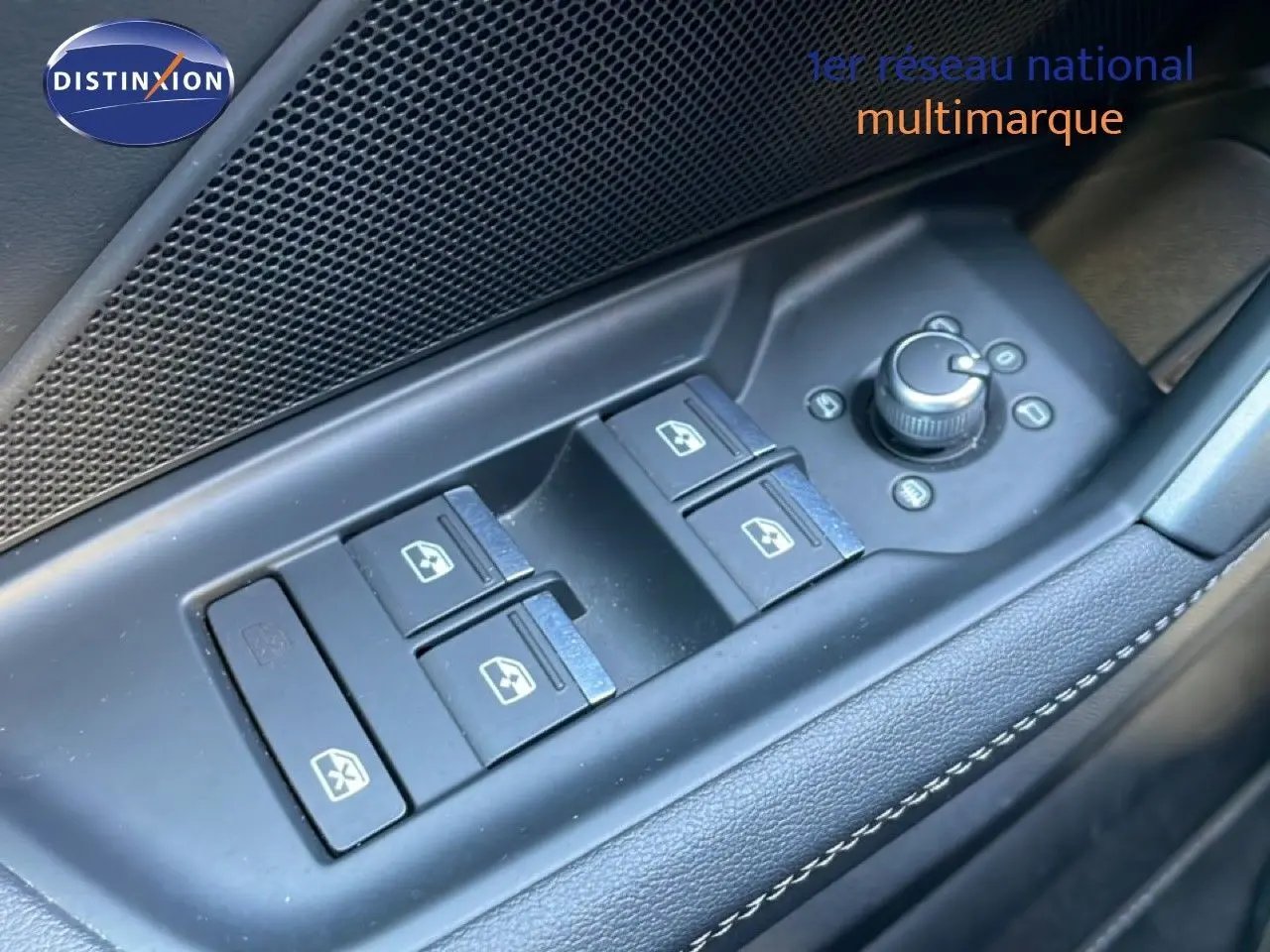 Gros plan sur les commandes de lève-vitres et réglages des rétroviseurs côté conducteur d'une Audi A3 Sportback noir mito metal 2025.