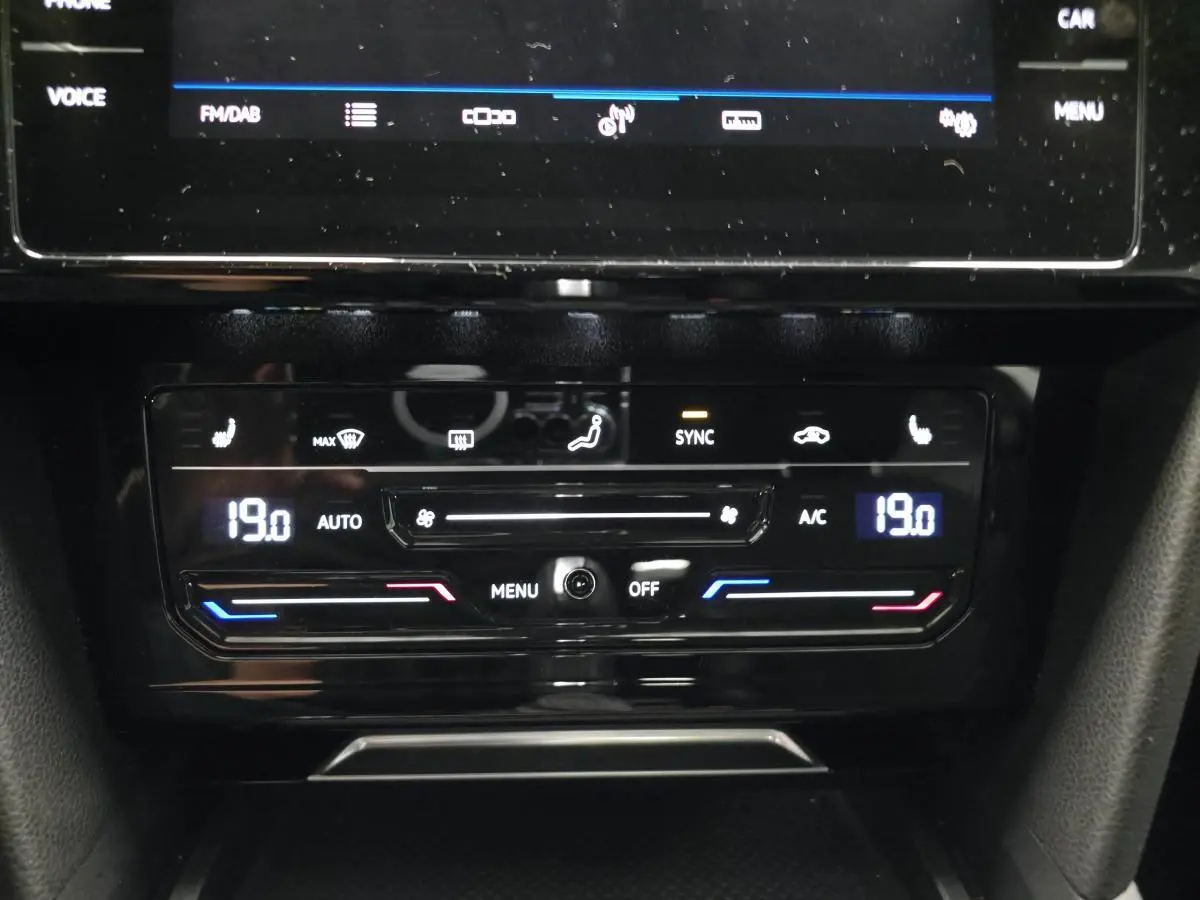 Panneau de commande de climatisation automatique avec affichage digital et réglages tactiles dans une Volkswagen Arteon blanche.