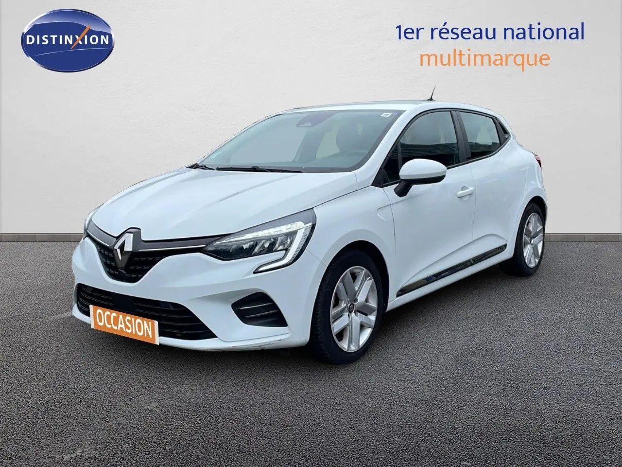 Renault Clio blanc glacier vue 3/4 avant droit, avec phares LED et jantes alliage visibles sur sol gris.