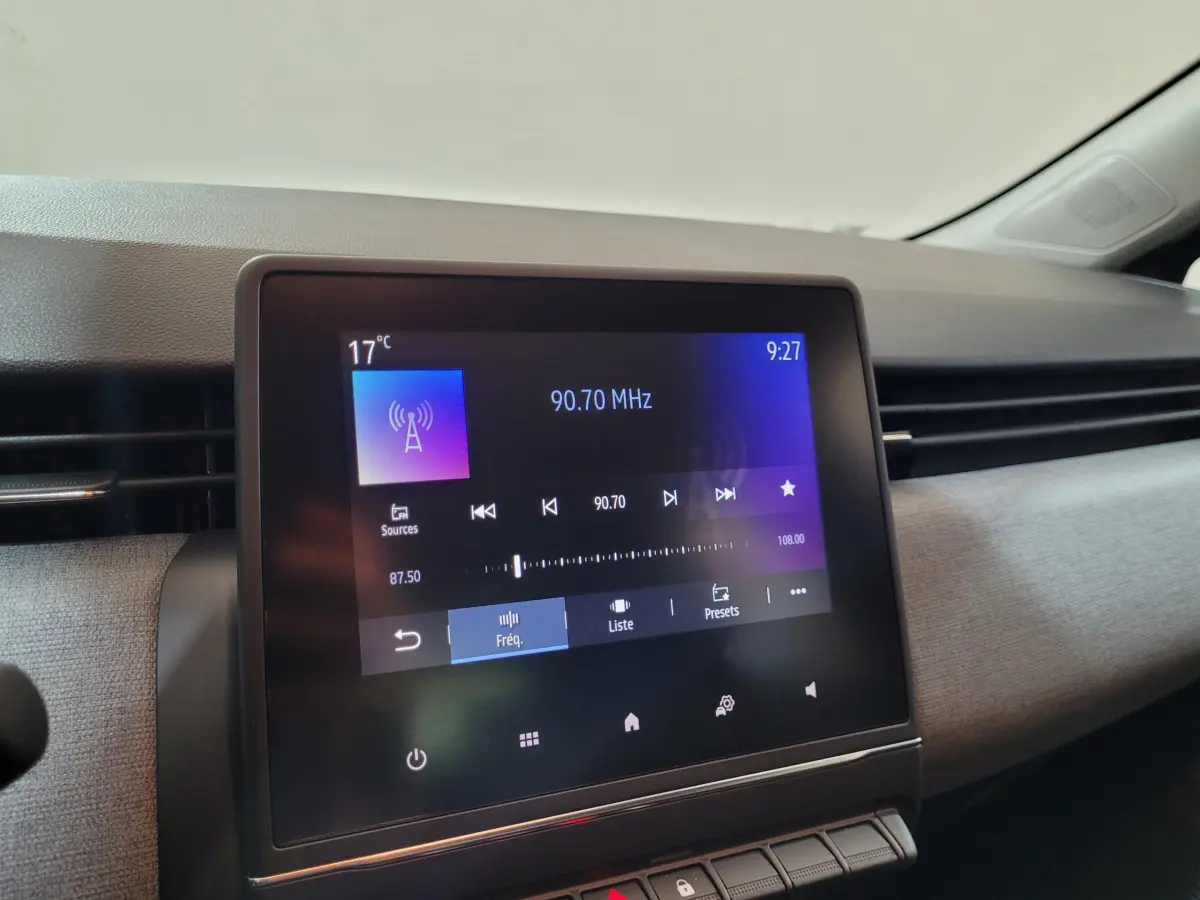 Écran tactile central de 17,8 cm affichant la radio dans l’habitacle d’une Renault Clio gris foncé, vue de face.