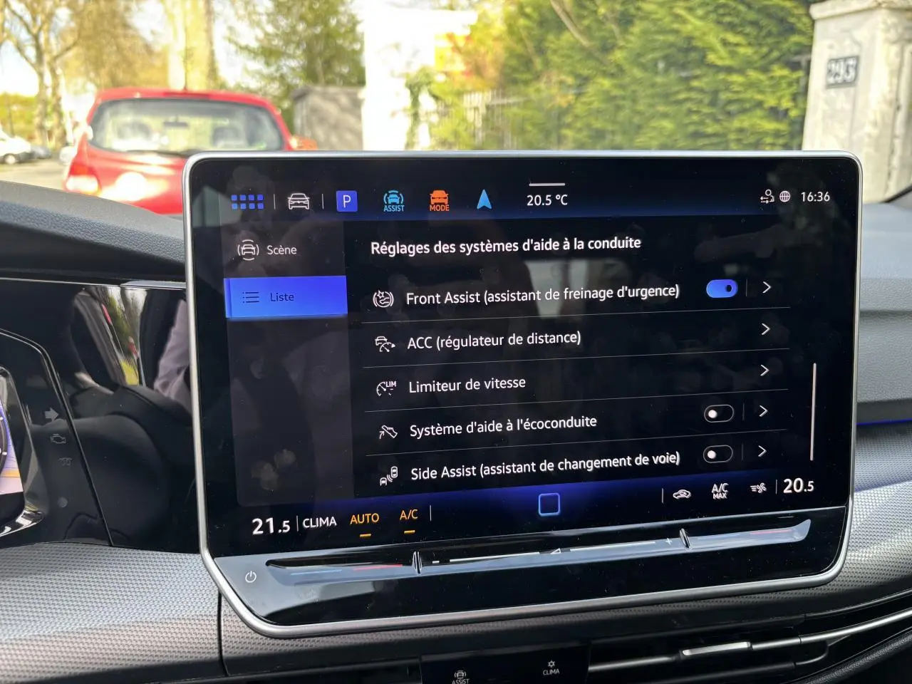 Écran tactile central de la Volkswagen Golf 1.5 eTSI 2024 montrant les réglages des aides à la conduite, intérieur noir.