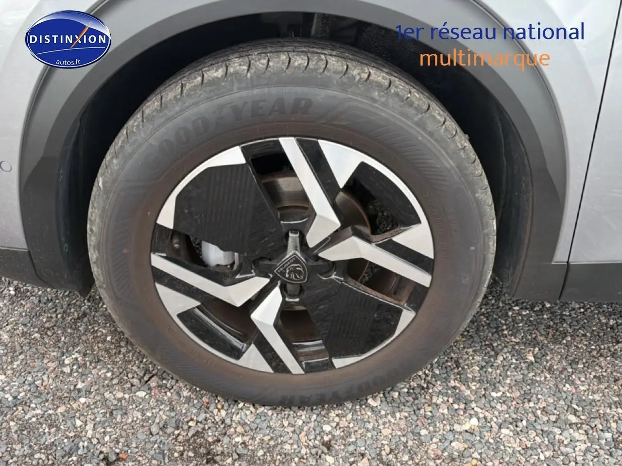 Gros plan sur la jante alu noire et argentée du côté avant droit d’un Peugeot 2008 gris Artense.