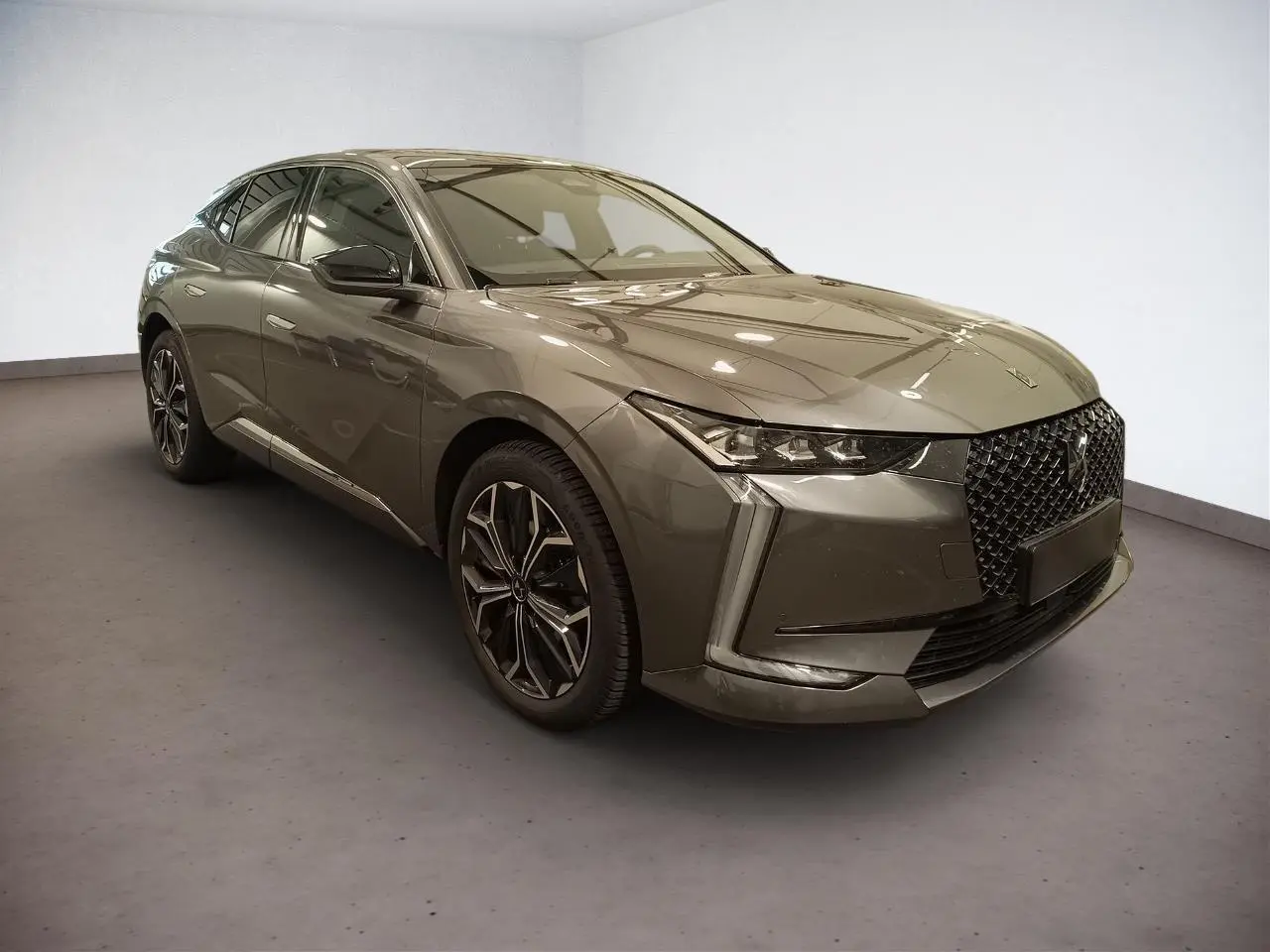 DS4 Gris Platinium en 3/4 avant droit, avec calandre distinctive et jantes alliage 19 pouces.