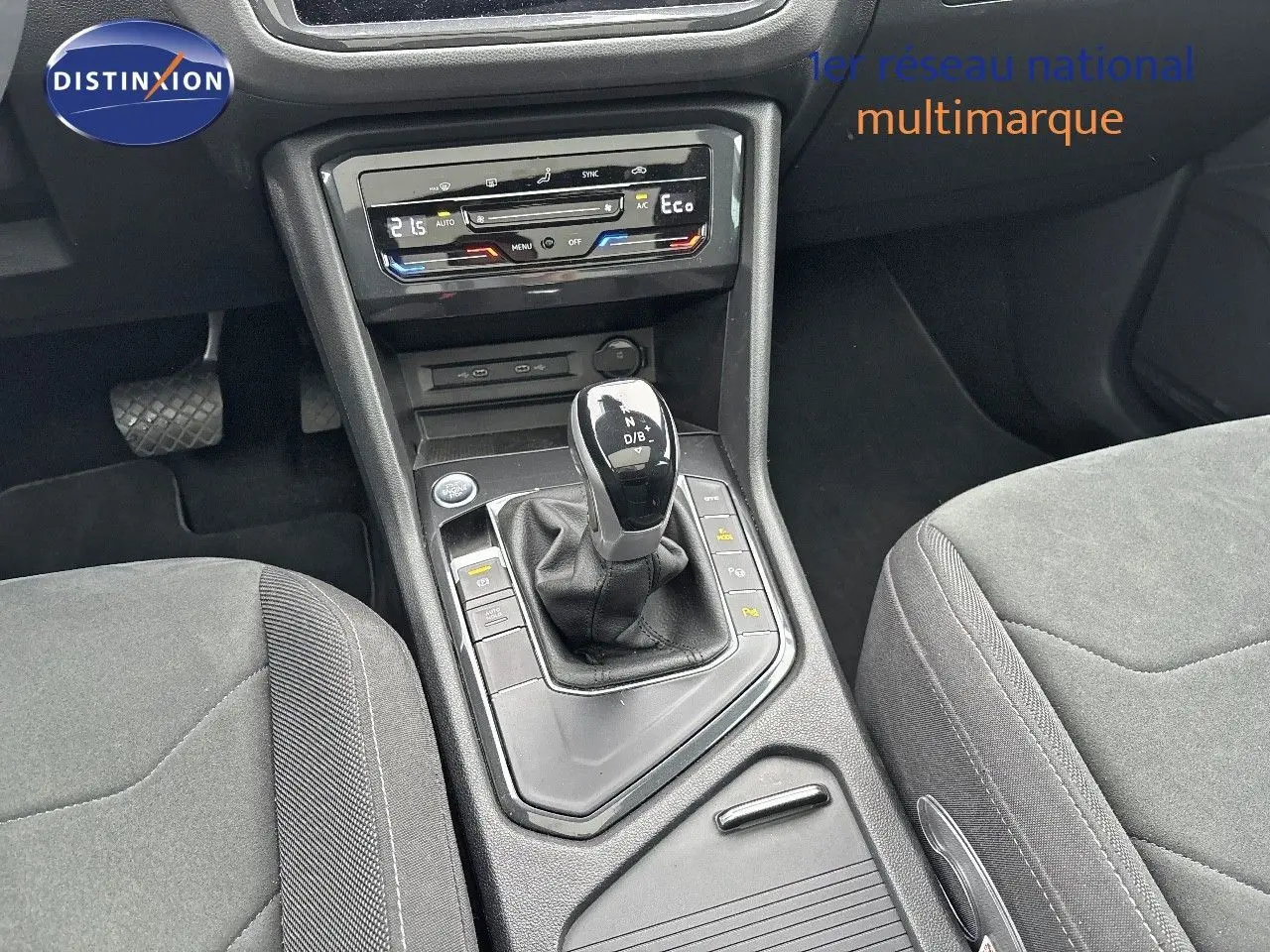 Vue rapprochée de la console centrale du Volkswagen Tiguan 1.4 E-HYBRID 2022 avec levier de vitesses automatique et commandes climatisation.