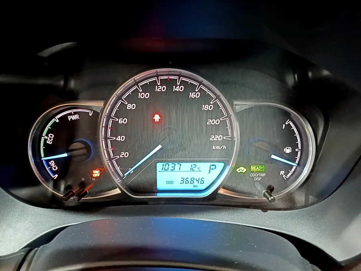 Tableau de bord de Toyota Yaris hybride 2020 avec compte-tours, vitesse, jauge essence et affichage digital bleu.