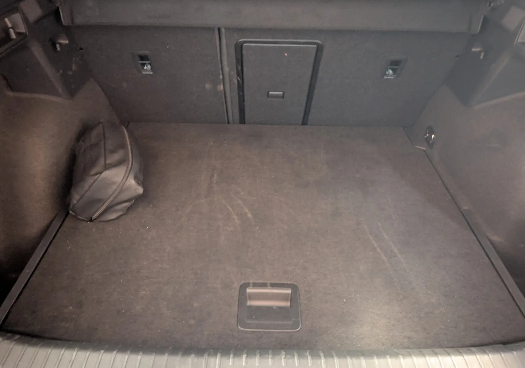 Coffre spacieux de CUPRA Formentor gris magnétique vu de dessus, avec sac noir dans un coin.