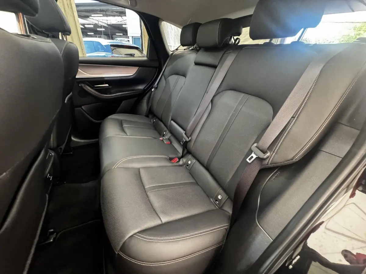 Vue intérieure côté droit montrant la banquette arrière en cuir noir du Mazda CX-60 2024 version Homura.