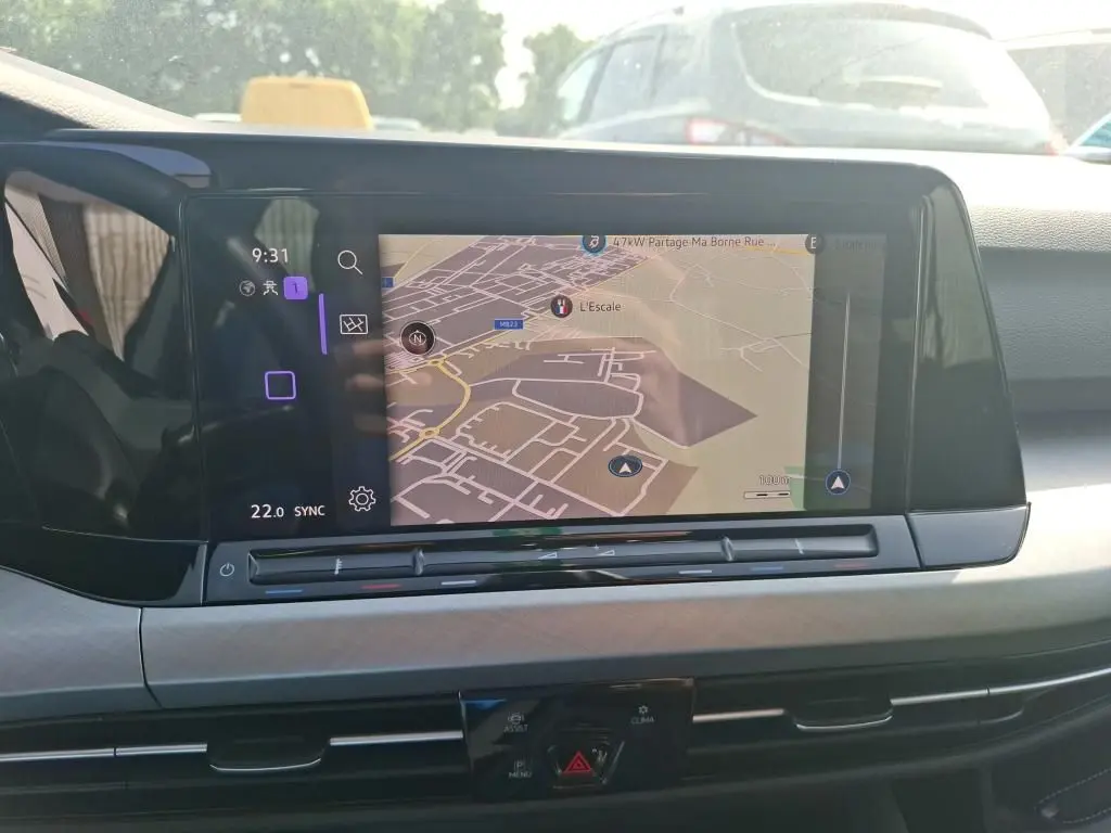 Écran tactile central affichant la navigation dans l’habitacle d’une Volkswagen Golf gris clair, vue de face.