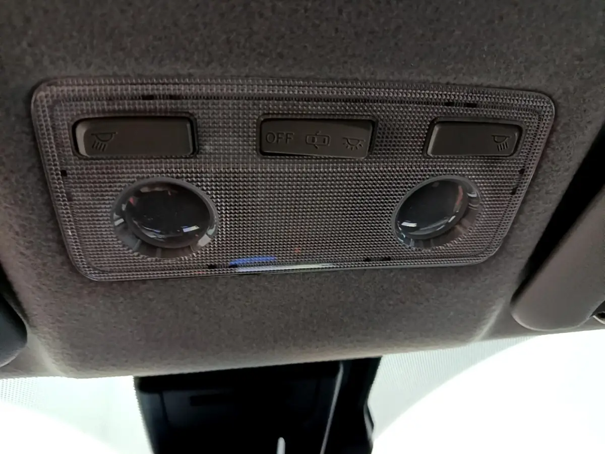 Vue intérieure en gros plan du plafonnier gris avec commandes d’éclairage de la Toyota Yaris blanche 2020 hybride.