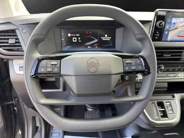 Vue rapprochée du volant noir du Citroën Jumpy 2026 avec commandes intégrées et tableau de bord numérique.