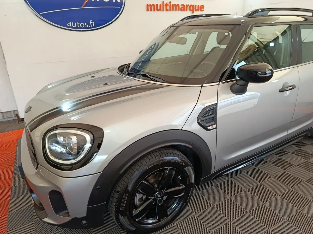 Vue 3/4 avant droit d'une MINI Countryman Cooper Premium Plus gris foncé avec jantes noires et toit noir.